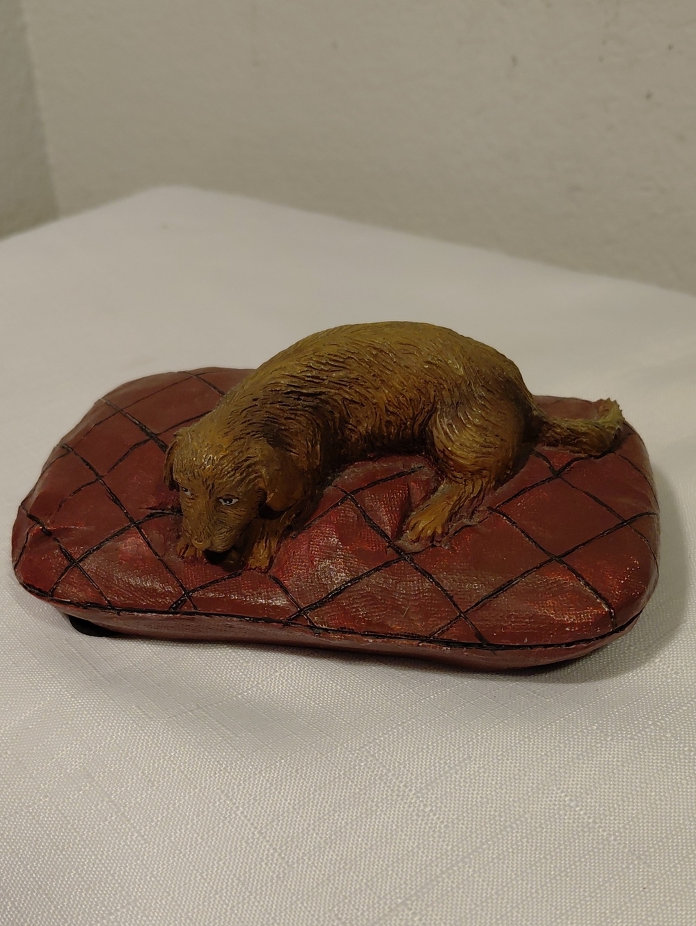 Sandicasr Sleeping Dog on Quilted Pillow